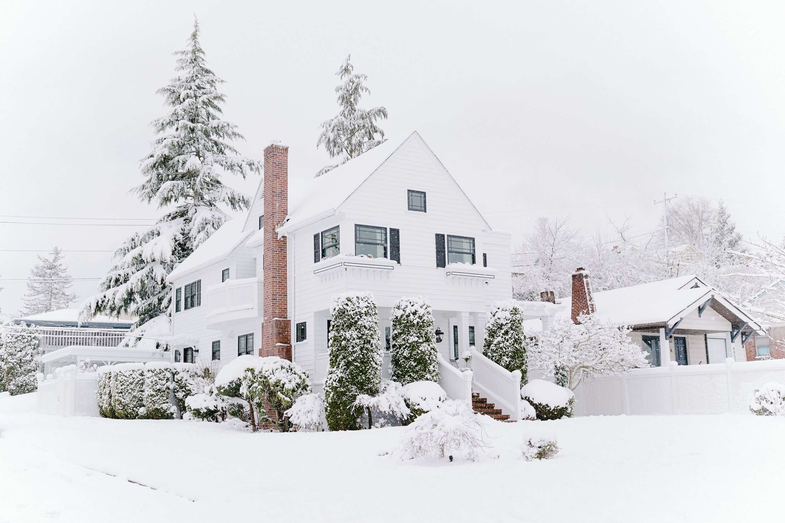 White Siding house covered in snow.