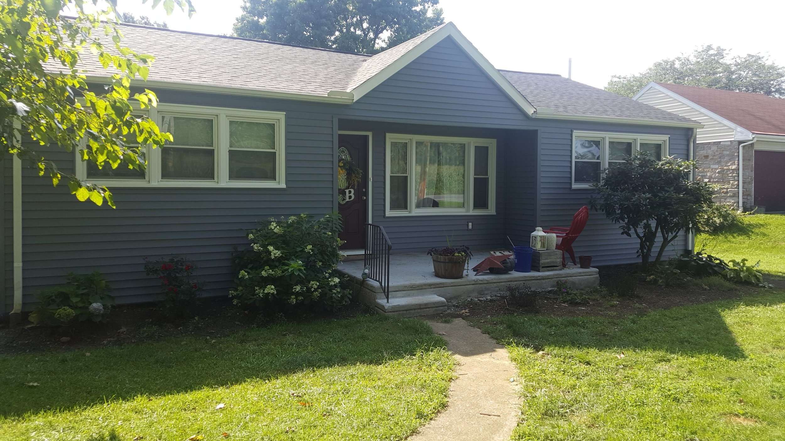 Front of house with blue vinyl siding