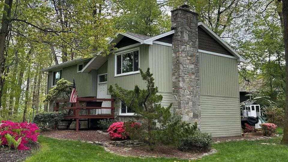 After Image with upgraded siding and new green siding color