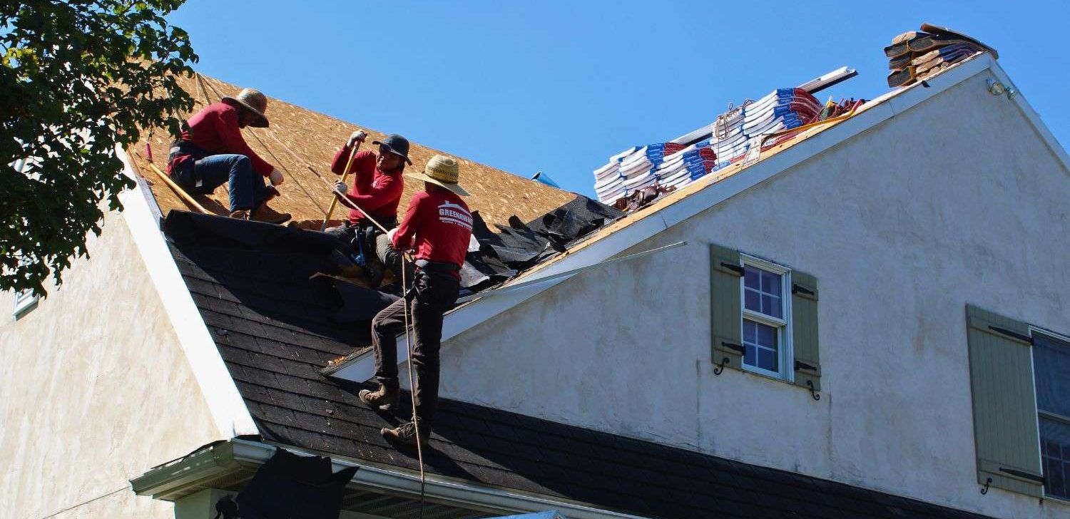 Roofing contractor installing a new roof